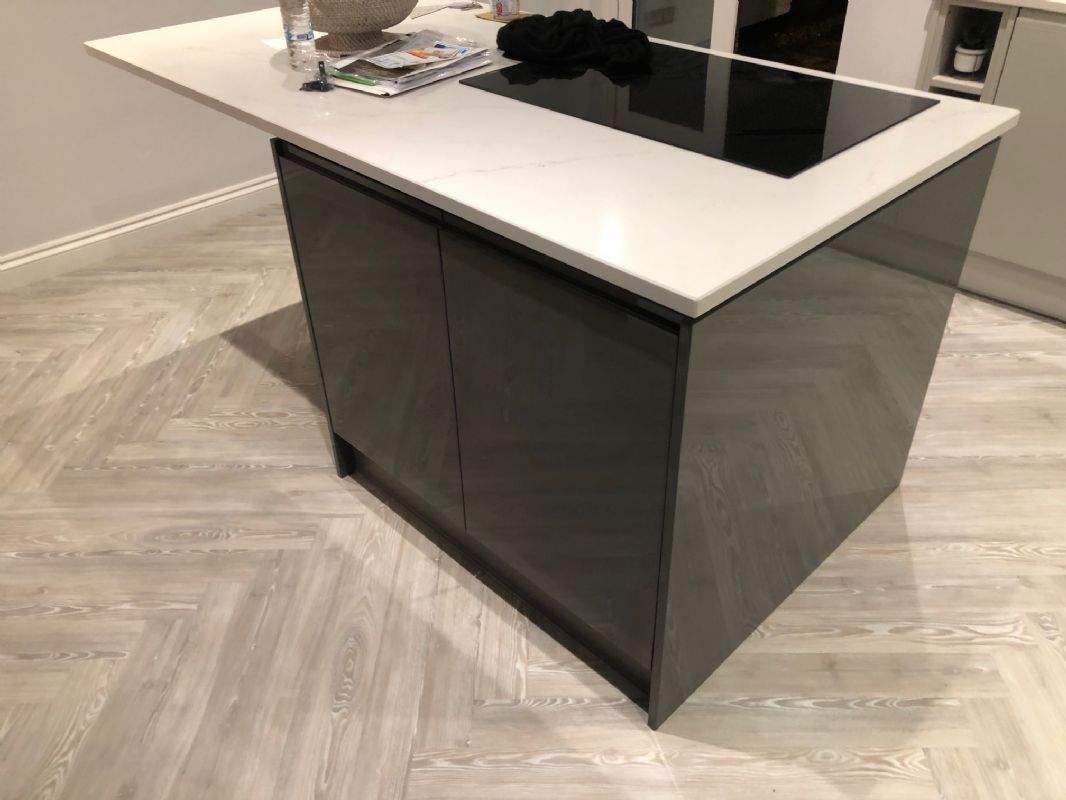 Limed herringbone luxury vinyl Shaun fitted around a stone-topped kitchen island