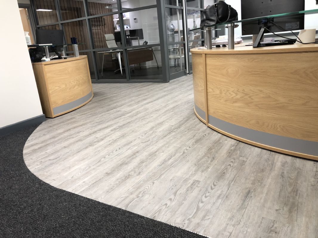 Karndean luxury vinyl Shaun laid around the curved wooden reception desk of an office